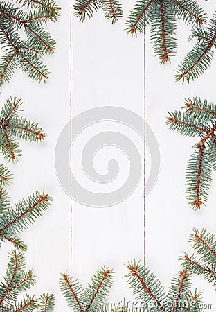 Fir branches in form of frame on white wooden table. Christmas and Happy New Year composition.Flat lay, top Stock Photo