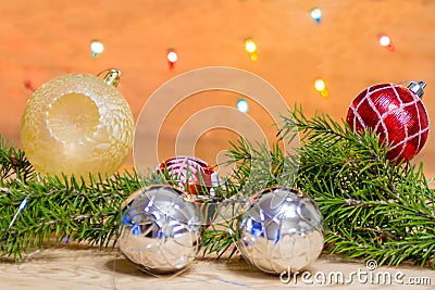 Fir branches with toys, glass balls, tinsel on a light wooden background.Christmas card Stock Photo