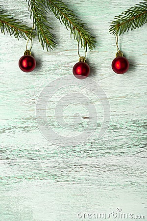 Fir spruce pine coniferous branches sparkling shiny multi-colored red balls on a brown matte wooden light background Stock Photo