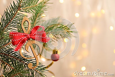 Fir tree branch with wooden treble clef Stock Photo