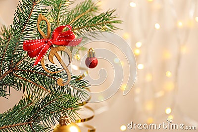 Fir tree branch with wooden treble clef Stock Photo