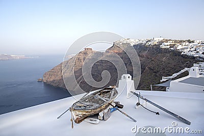 Fira panoramic view. Thira panoramic sea view. Greece Santorini island in Cyclades. Old boat on a terrace with view over Caldera, Stock Photo