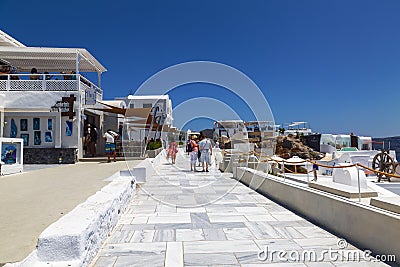 Fira on a sunny summer day with walking tourists. Santorini, Editorial Stock Photo