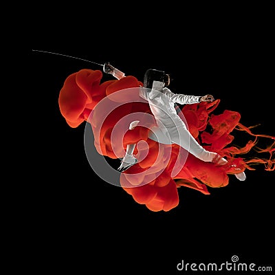 Collage of athlete, female swordsman in explosion of colored neon red smoke fluid isolated on black background. Stock Photo