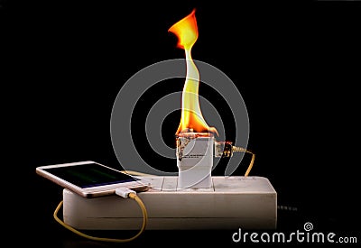 On fire adapter charger mobile at plug Receptacle on black background Stock Photo