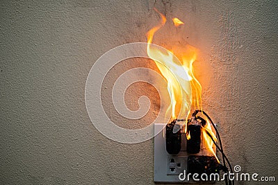 On fire adapter at plug Receptacle on white background Stock Photo