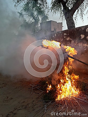 Fire in agriculture wastage / a farmer gave fire to woods and hence flames are appearing Stock Photo