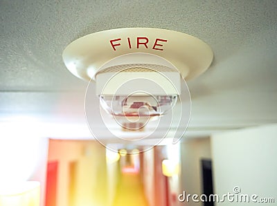 Smoke detector mounted on roof in apartment Stock Photo