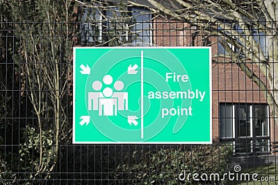 Fire assembly point sign at office workplace factory for safety security of workers people employees Stock Photo