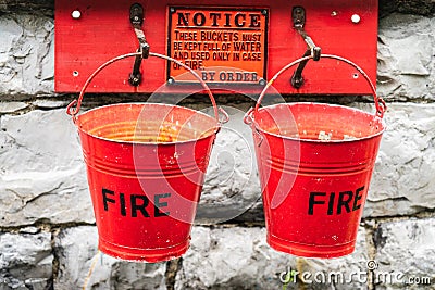 A fire buckets is a buckets filled with water or sand which is used to prevent or extinguish fires Stock Photo