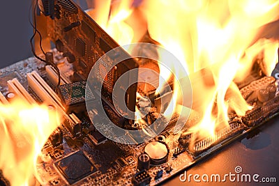 Fire Burning ,blazing computer motherboard, cpu,gpu and video card, processor on circuit board with electronic Stock Photo