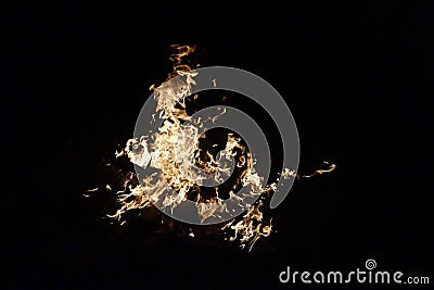 A fire burning in the dark. Red and yellow heat energy light, in the night. Fire on a black background Stock Photo