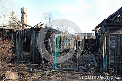 After fire - burnt house. Black burned wooden walls, lot Stock Photo