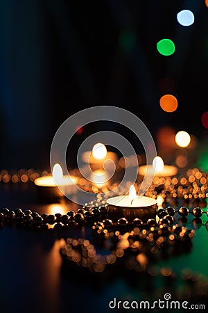 Christmas candles burning at night. Abstract candles background. Golden light of candle flame. Hope, fire. Stock Photo