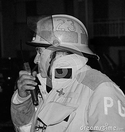Fire chief talking on the radio at the scene of a fire Editorial Stock Photo
