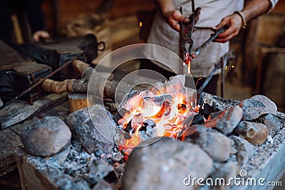 Fire crackling in blacksmith workshop of forging metal. Anonymouse craft smith create objects from wrought iron or steel Stock Photo