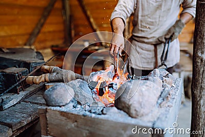 Fire crackling in blacksmith workshop of forging metal. Anonymouse craft smith create objects from wrought iron or steel Stock Photo