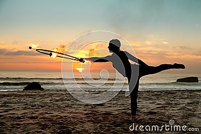 Fire dancer against sunset Stock Photo