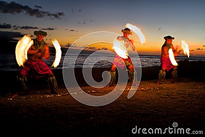Fire Dancers at Dusk on the Beach Stock Photo