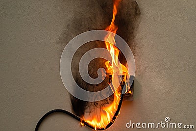 On fire electric wire plug Receptacle on the concrete wall exposed concrete backgroun Stock Photo