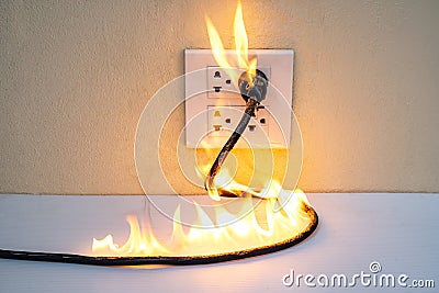 On fire electric wire plug Receptacle wall partition Stock Photo