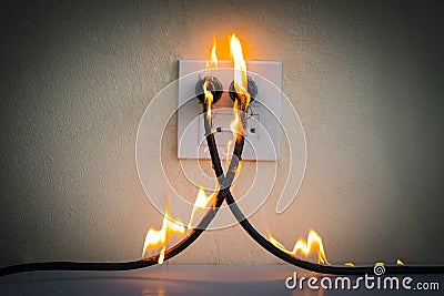 On fire electric wire plug Receptacle wall partition Stock Photo
