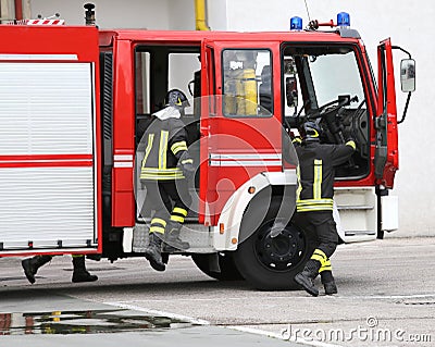 fire engine with many firefighters and equipment for fighting fire Stock Photo