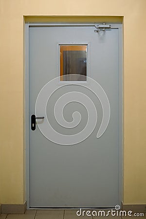 Fire exit door. Gray metal emergency exit door in building Stock Photo