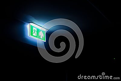 Fire Exit Sign in a dark room, with copy space Stock Photo