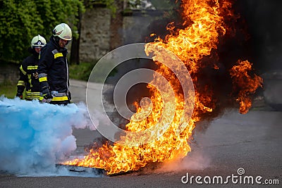 Fire extinguisher demonstration with burning fire Editorial Stock Photo