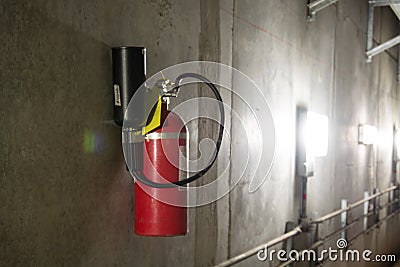 Fire extinguisher in dimly lit corridor Stock Photo