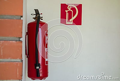 The fire extinguisher is suspended on the wall Stock Photo