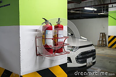 Fire extinguisher in underground basement car parking Editorial Stock Photo