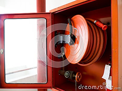 Fire extinguisher with various types of fire extinguishers Located In the white wall. copy space for text and content Stock Photo