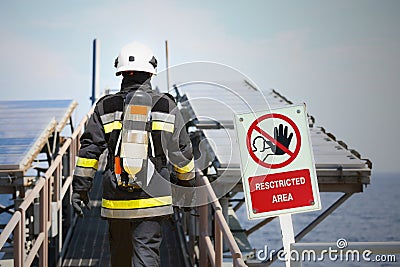 Fire fighter on oil and gas industry, successful firefighter at work , Fire suit for fighter with fire and suit for protect fire Stock Photo