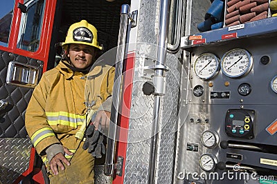 Fire Fighter Sitting At Fire Brigade's Door Stock Photo