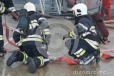 Fire fighters preparing hoses Stock Photo