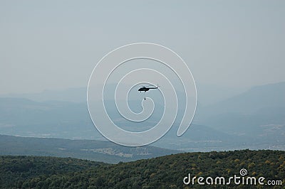 Fire fighting helicopter with waterbag Stock Photo