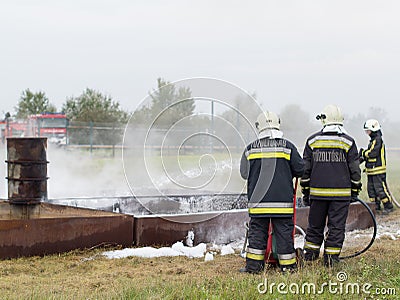 Fire fighting with a water extinguisher Editorial Stock Photo