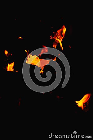 Fire in the fireplace black background. Red and yellow flame blaze, thermal energy during the night Stock Photo