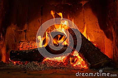 Fire in a fireplace with logs and flames creating a sense of warmth and coziness Stock Photo