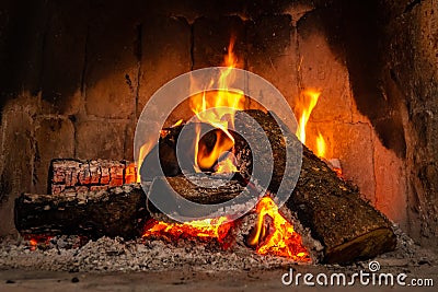 Fire in a fireplace with logs and flames creating a sense of warmth and coziness Stock Photo