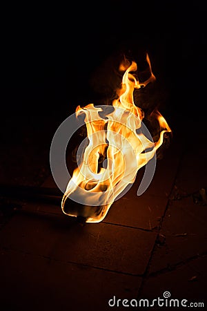 Fire flame background. Flaming torch on dark background Stock Photo