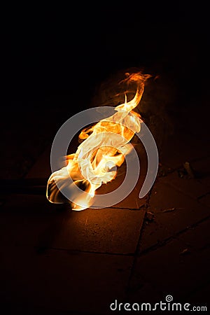 Fire flame background. Flaming torch on dark background Stock Photo