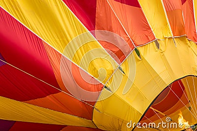 Fire fuels a hot air balloon in yellow, orange and red Stock Photo