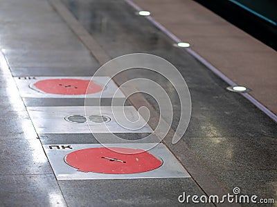 Fire hatches at the Moscow metro station. Red covers on the floor of the platform at the wells with fire hydrants in the subway Stock Photo