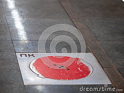 Fire hatches at the Moscow metro station. Red covers on the floor of the platform at the wells with fire hydrants in the subway Stock Photo