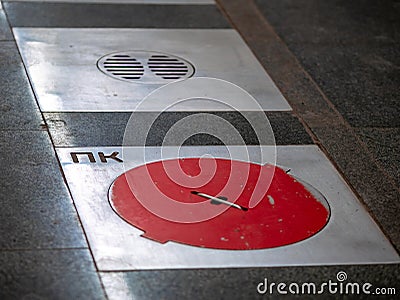 Fire hatches at the Moscow metro station. Red covers on the floor of the platform at the wells with fire hydrants in the subway Stock Photo