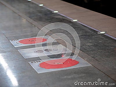 Fire hatches at the Moscow metro station. Red covers on the floor of the platform at the wells with fire hydrants in the subway Stock Photo