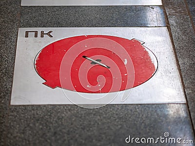 Fire hatches at the Moscow metro station. Red covers on the floor of the platform at the wells with fire hydrants in the subway Stock Photo